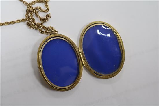 An engraved 9ct gold oval locket on a 9ct chain, locket 4cm.